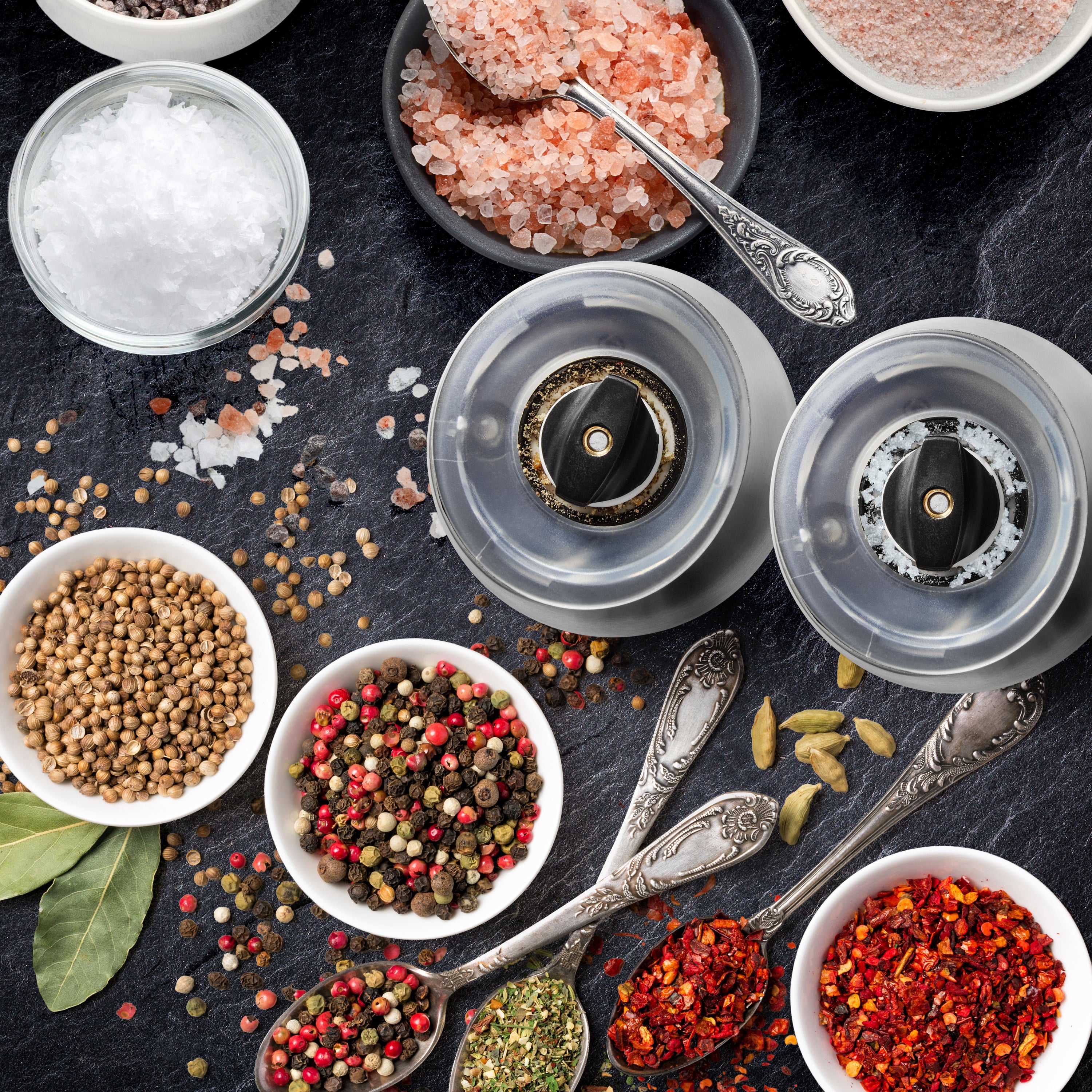 Duronic Electric Salt and Pepper Grinder Set with bowls of colorful spices, sea salts, vintage spoons, and modern spice grinders.