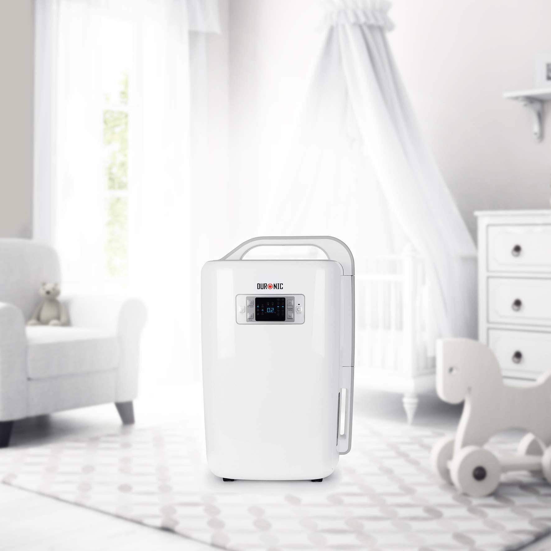 Duronic Dehumidifier with a digital display and integrated carry handle, shown in a bright and airy nursery setting.
