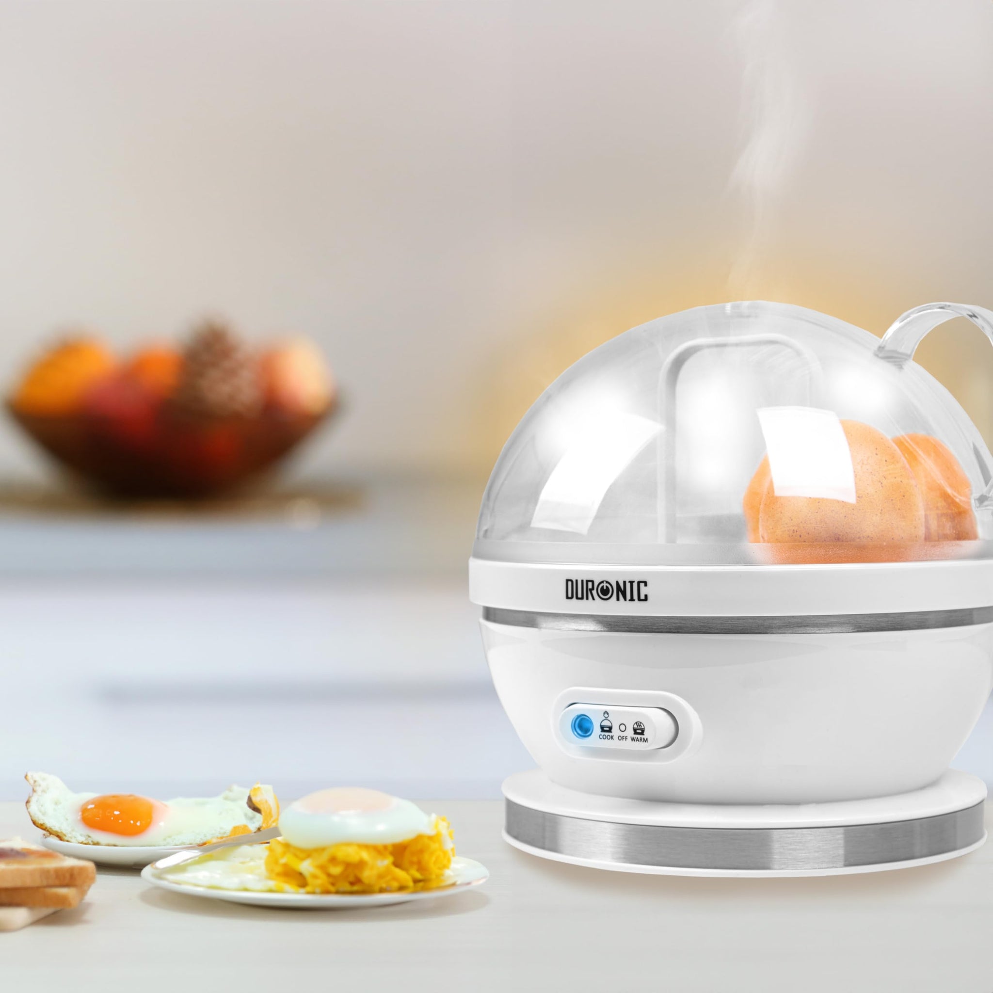 Duronic EB27 WE electric egg cooker placed on aesthetic kitchen countertop cooking eggs alongside egg dishes