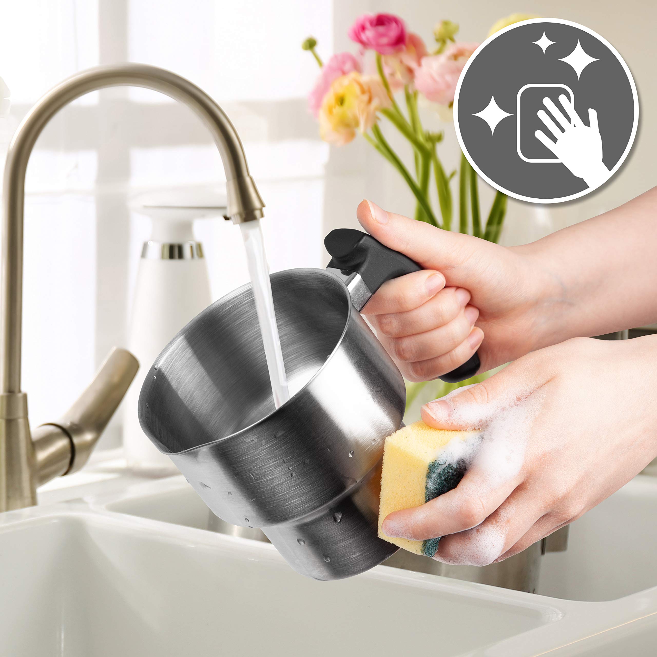 Duronic MF500 BK electric milk frother shown being hand-washed, depicting how easy it is to clean whether that's by hand washing, or by using a dishwasher