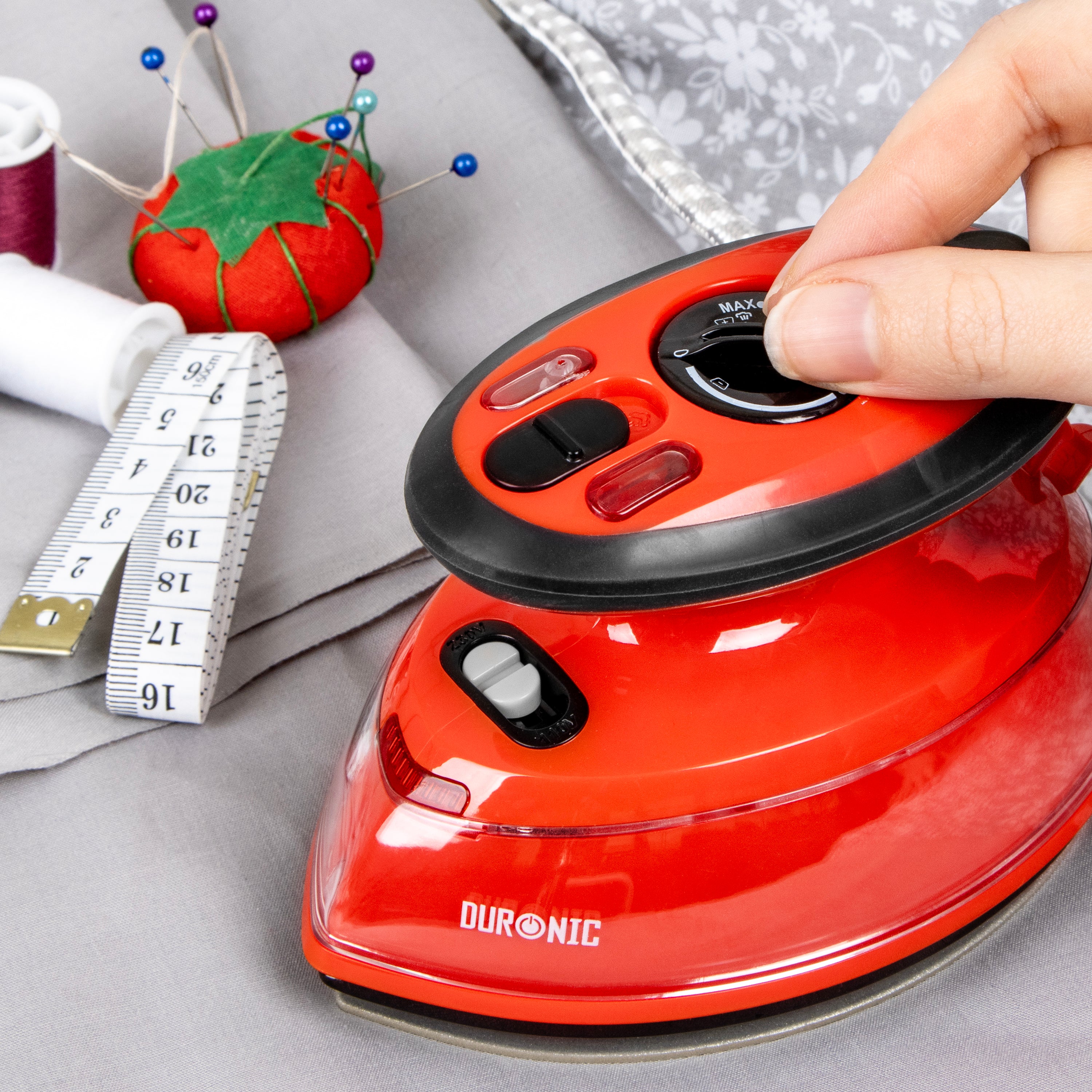 Red travel iron in use