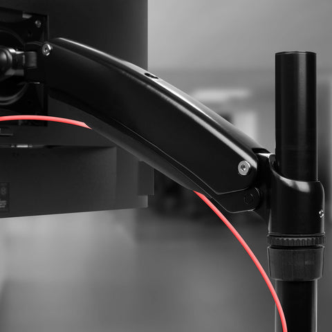 Duronic Monitor Arm Stand attached to a vertical desk pole holding a computer screen.