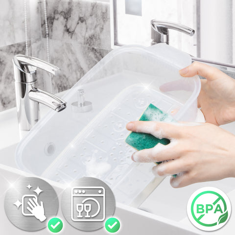 Duronic Black Electric Food Steamer using a green sponge in a bathroom sink.