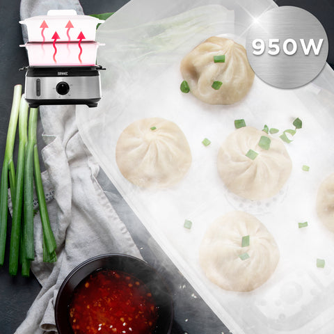 Duronic Black Electric Food Steamer with steaming hot dumplings, green onions, and dipping sauce.