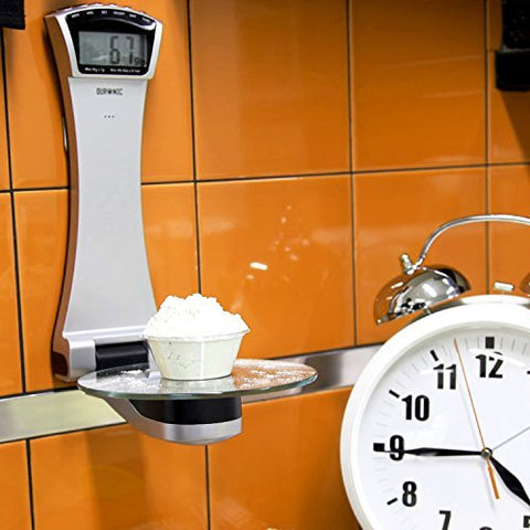 Duronic Digital Kitchen Scale weighing flour on a glass platform next to a white alarm clock.