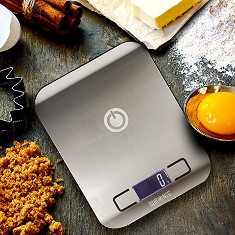 Duronic Digital Kitchen Scales surrounded by baking ingredients like flour, eggs, and sugar.