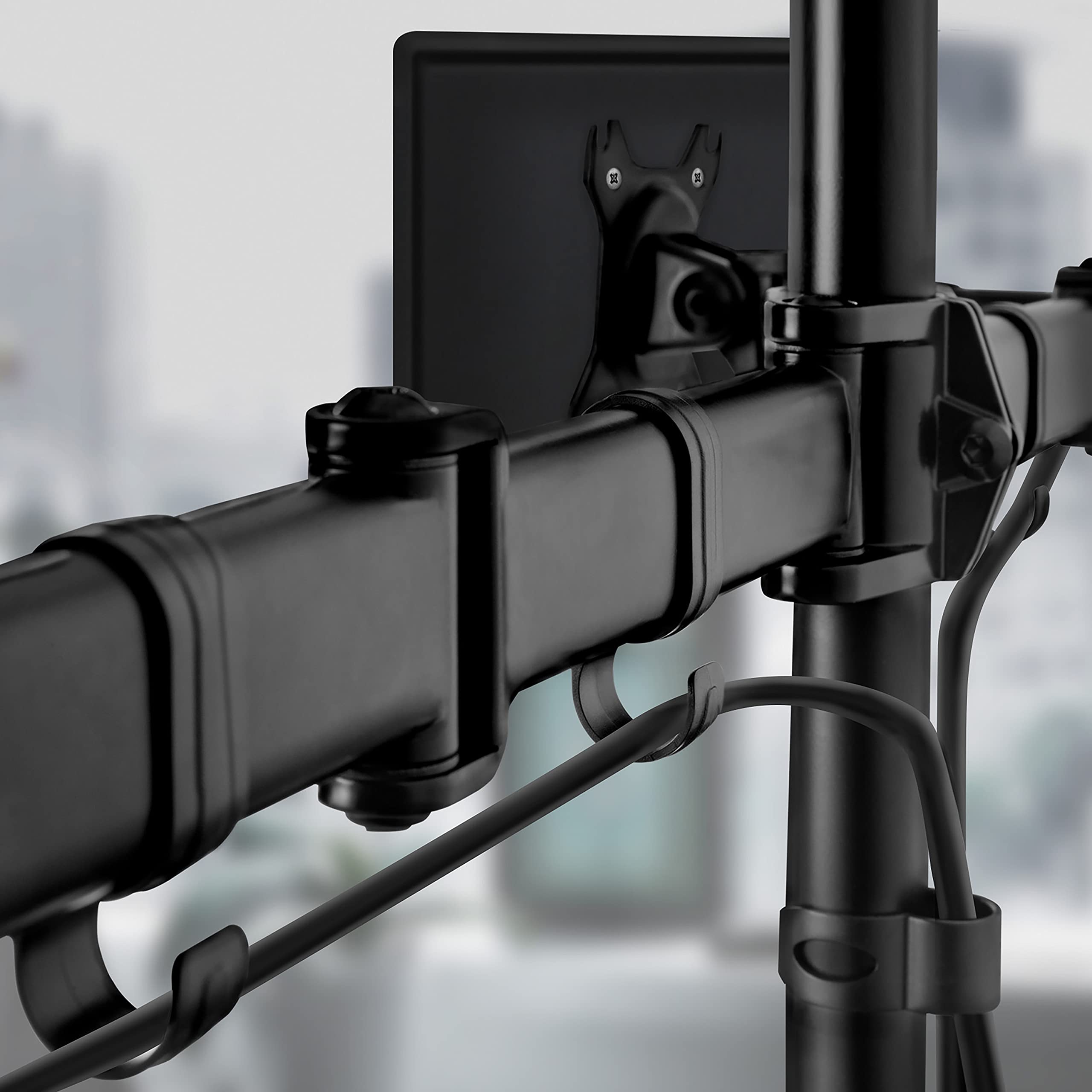 Duronic Dual Monitor Arm Stand Desk Mount featuring integrated cable management clips attached to a vertical desk pole.