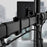 Duronic Dual Monitor Arm Stand Desk Mount featuring integrated cable management clips attached to a vertical desk pole."