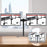Duronic Dual Monitor Arm Stand Desk Mount holding two screens, displaying product specifications on a wooden table.