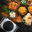 Duronic Electric Hot Plate HP1 WE sitting beside an assortment of colorful Indian food dishes.