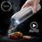 Duronic Electric Salt and Pepper Grinder Set with LED light over cooked steak.