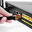 Duronic Ethernet Cable close-up of a hand plugging a high-performance gold-plated Ethernet cable into the rear port of a black gaming router.