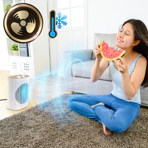 Duronic HV32 Electric Fan Heater with a young woman using the portable fan heater provides a cooling breeze in a bright living room.