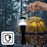 Duronic LED Torch hangs from a person's finger against a rainy forest backdrop with a glowing yellow tent.