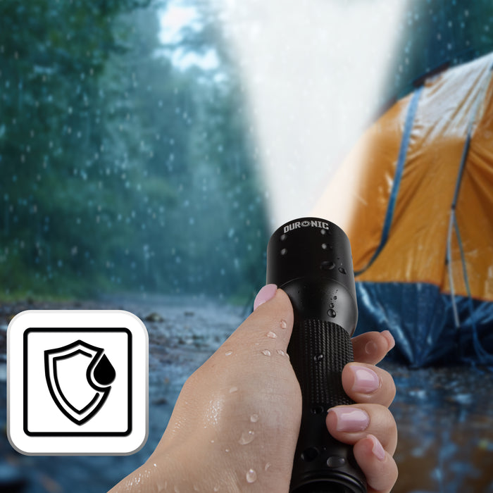 Duronic LED Torch illuminating a tent in rainy outdoor camping conditions with water droplets.