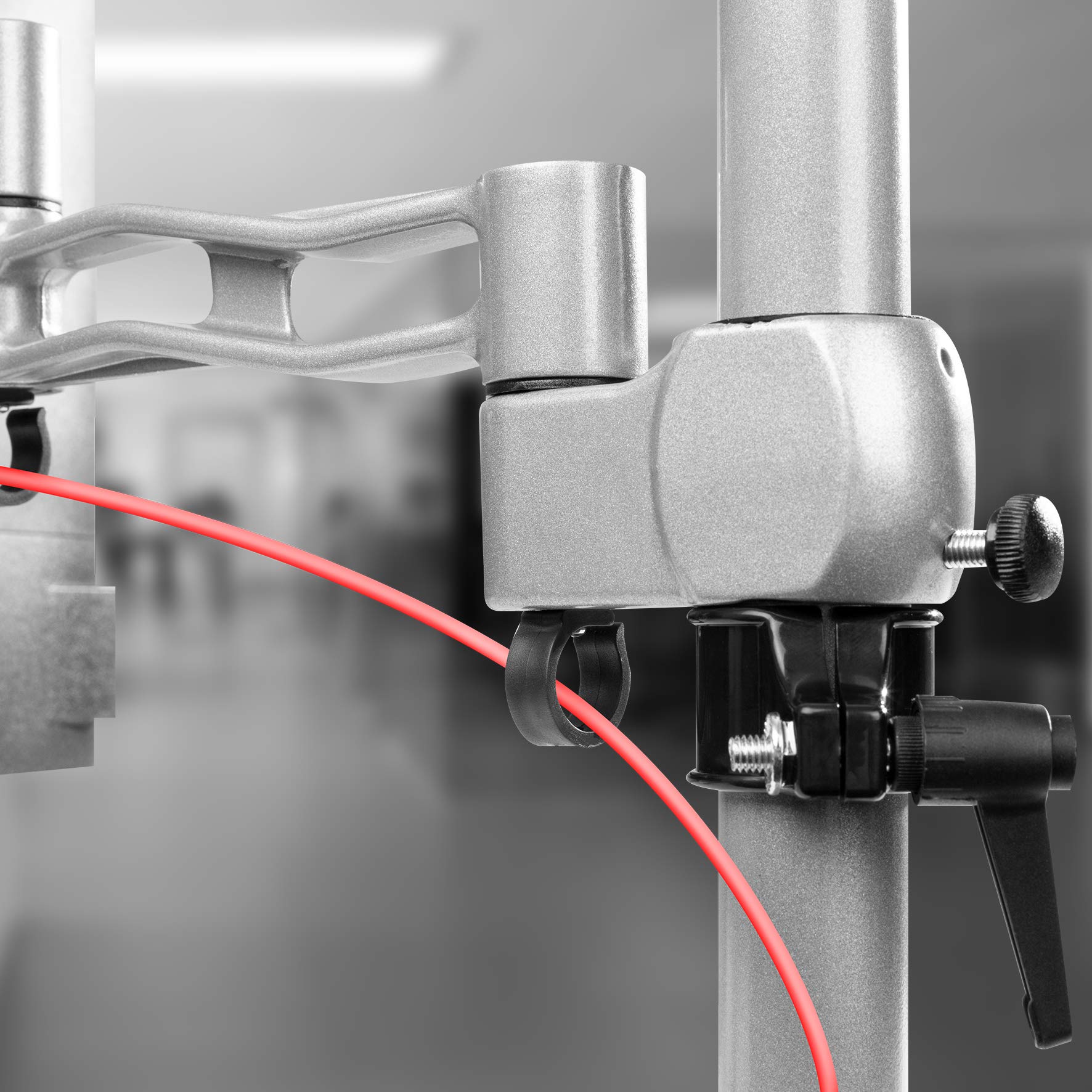 Duronic Monitor Arm Single Silver with cable management clip holding a thin red cord.