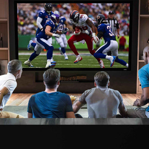 Duronic Projector Screen w Four men watching an American football game on a large, high-definition television screen at home.