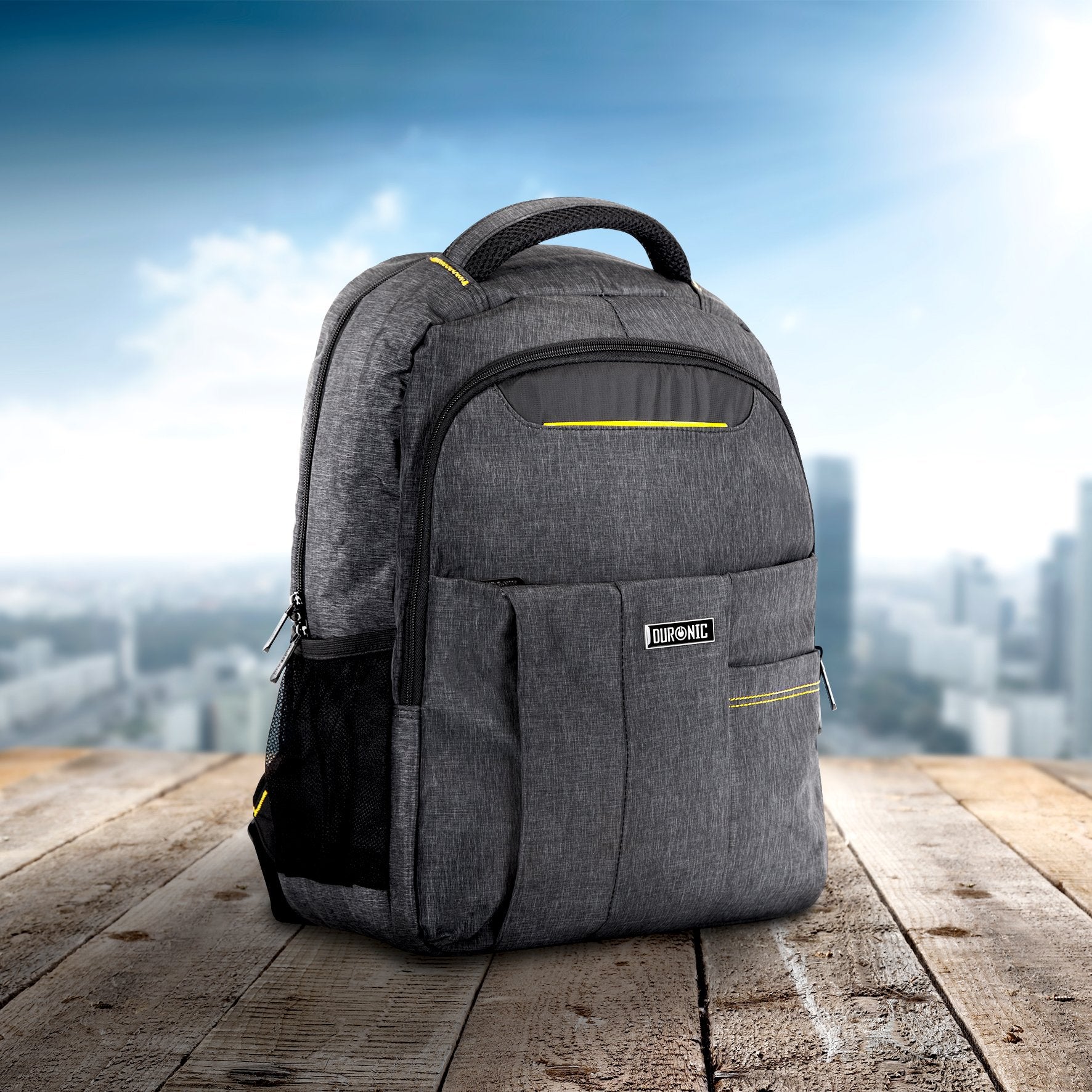 Duronic Travel Laptop Backpack with yellow accents on a wooden table, featuring a city skyline background.