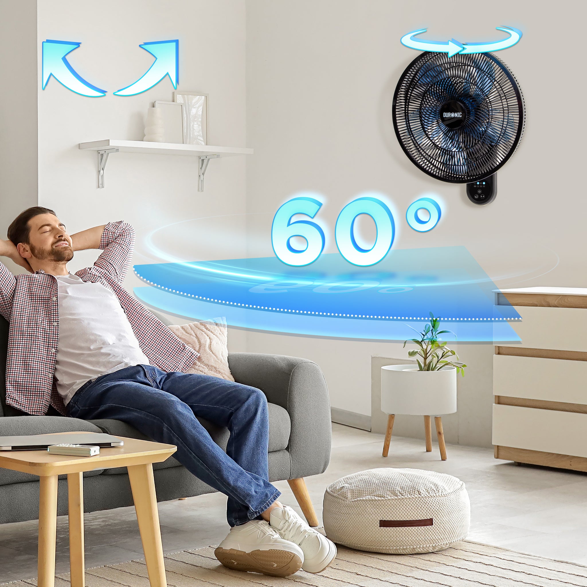 Duronic Wall Mounted Fan with a man relaxing on a living room sofa