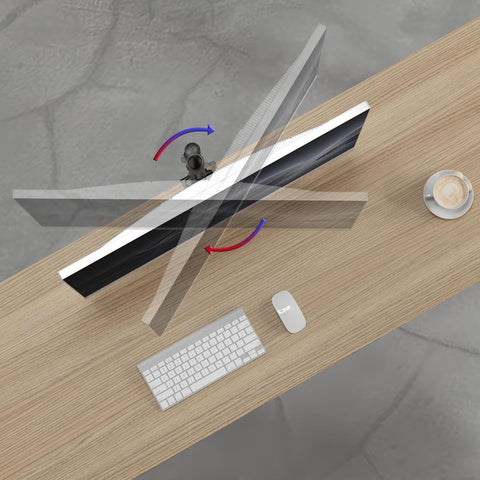 Top-down view of a computer monitor on an adjustable arm rotating over a wooden desk.