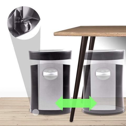 Duronic Cross Cut Paper Shredder with hidden caster wheels sliding easily under a wooden desk.