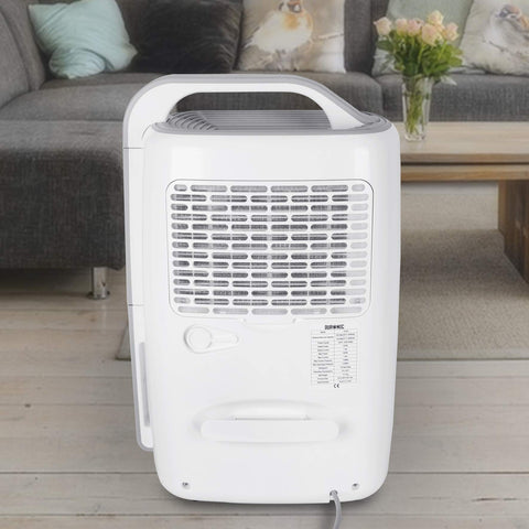 Duronic Dehumidifier featuring a built-in handle, air intake grille, and technical specification label in a living room setting.