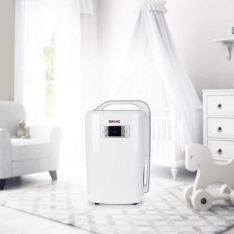 Duronic Dehumidifier with a digital display and integrated carry handle, shown in a bright and airy nursery setting.