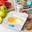 Duronic Digital Kitchen Scales weighing flour and a cracked egg with a blue backlit display.