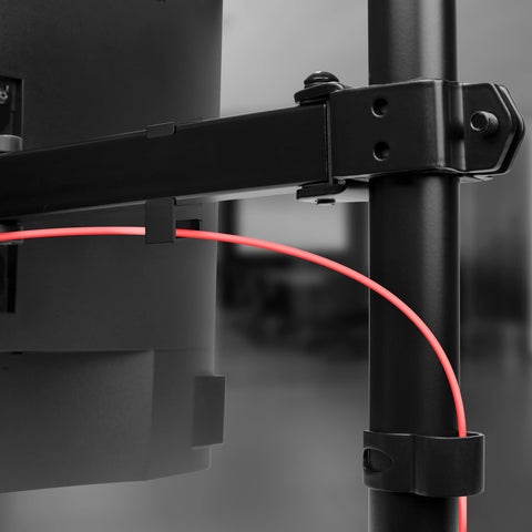 Duronic Dual Monitor Stand featuring integrated cable management clips holding a red power cable.