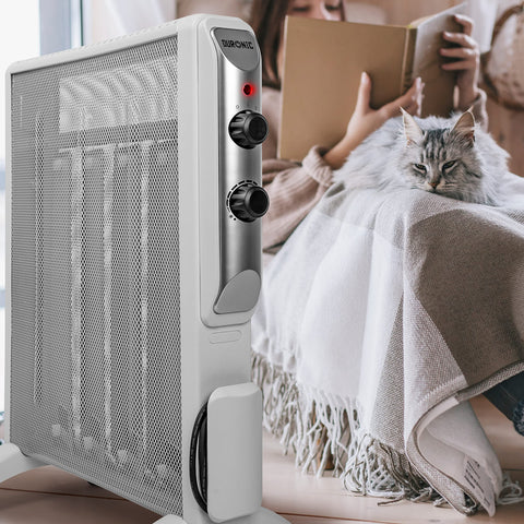 Duronic Electric Heater standing on floor near a person and cat reading.