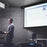 Duronic Electric Projector Screen with a man presenting in podium
