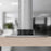Duronic Grommet securely attached to a light wood desk surface, close-up view.