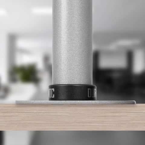 Duronic Grommet securely attached to a light wood desk surface, close-up view.