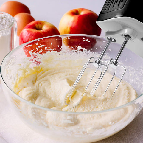 Duronic Hand Mixer Electric Whisk blending creamy batter in a glass bowl with apples in background.