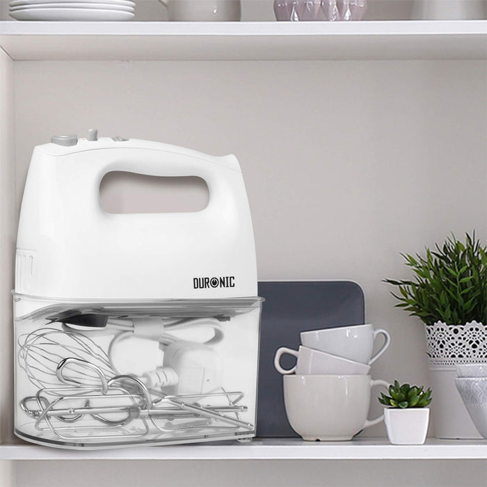Duronic Hand Mixer Electric Whisk resting on a clear storage case containing whisks and power cord.