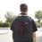 Duronic Laptop Backpack with red zipper accents, walking down an outdoor street.