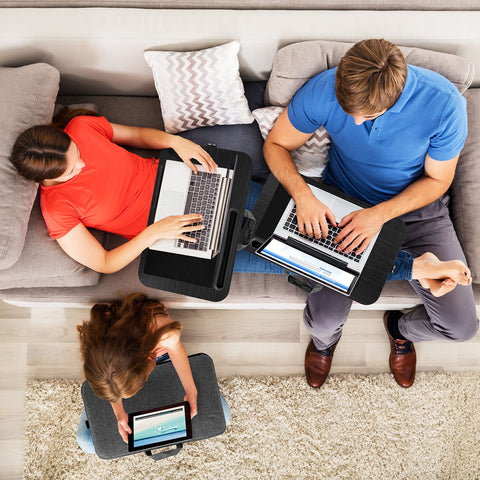 Duronic Laptop Tray with Cushion with Family using portable lap desks for laptops and tablets while relaxing on a living room sofa.