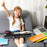 Duronic Laptop Tray with Cushion with stationery and laptop for remote learning.