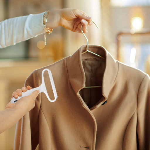 Duronic Lint Shaver used on a tan wool coat to remove fuzz and pilling.