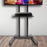 Duronic Mobile TV Stand on Wheels featuring a media shelf holding a streaming device