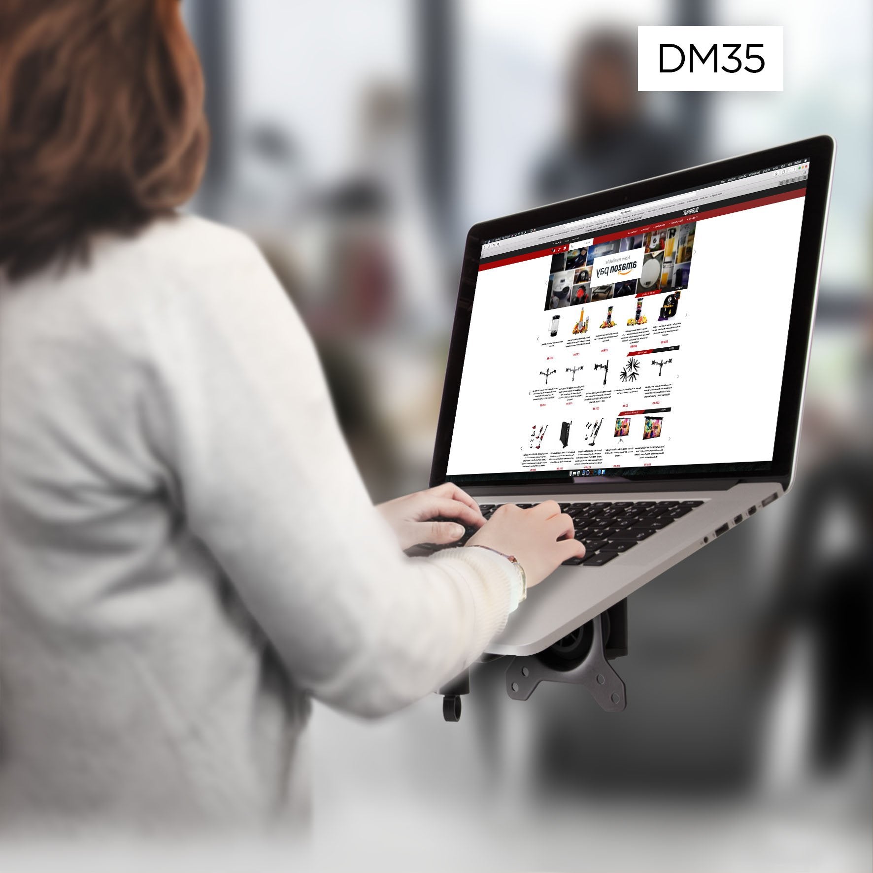 Duronic Monitor Arm Laptop Attachment with woman typing on a laptop mounted on a DM35 ergonomic desk arm stand.