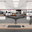 Duronic Monitor Arm Stand holding three side-by-side screens above a modern office workspace.