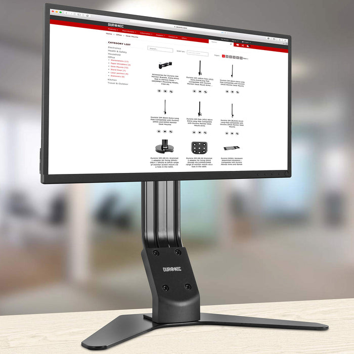 Duronic Monitor Arm Stand supporting a widescreen computer screen on a wooden table.