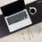 Duronic Monitor Stand Riser featuring a white laptop, a coffee mug, pencils, and notepad.