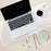 Duronic Monitor Stand Riser with Laptop, coffee cup, and notes on a clear acrylic desk mat over a textured background