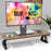 Duronic Monitor Stand Riser with black triangular legs, supporting a monitor on a white desk.
