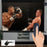 Duronic Projector Screen Electric displaying a live boxing match, operated by a hand holding a remote control.