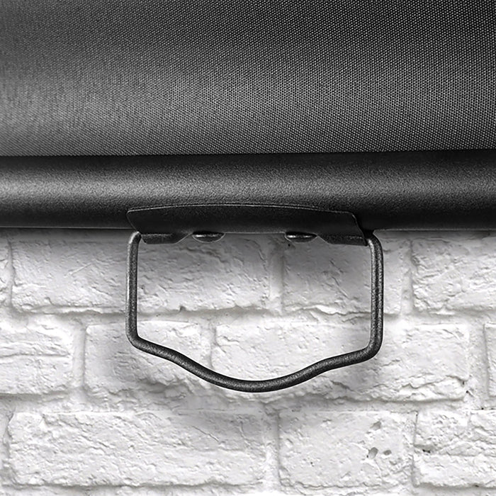 Duronic Projector Screen showing with close up view of black pull down handle on a screen against white brick wall.
