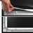 Duronic Projector Screen with A hand pulls back a projector screen material to show the inner frame and tension pegs.