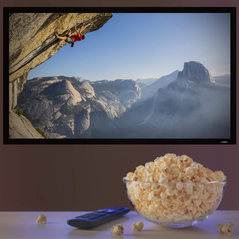 Duronic Projector Screen with Large glass bowl of popcorn and a remote control in front of a TV.